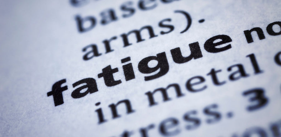 Close-up of a dictionary page with the word fatigue in bold black print.