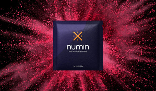 Brain health supplement Numin packet displayed against an energetic burst of red powder symbolizing enhanced focus and cognitive vitality