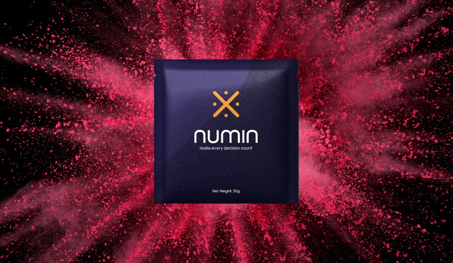 Brain health supplement Numin packet displayed against an energetic burst of red powder symbolizing enhanced focus and cognitive vitality