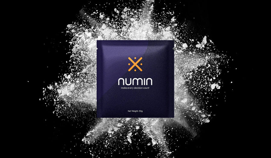Cognitive booster supplement Numin packet displayed against an explosive white powder background symbolizing mental clarity and energy