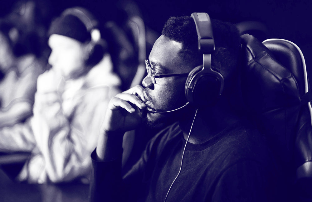 Man in headphones contemplating decisions while working, illustrating mental fatigue from daily choices