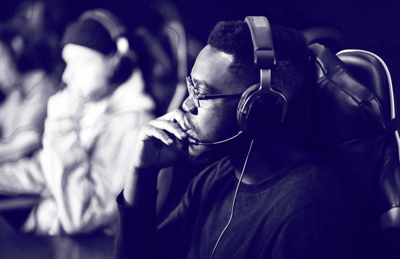 Man in headphones contemplating decisions while working, illustrating mental fatigue from daily choices