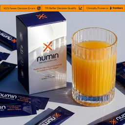 Numin decision fatigue supplement box beside a glass of mixed drink and scattered stick packets.