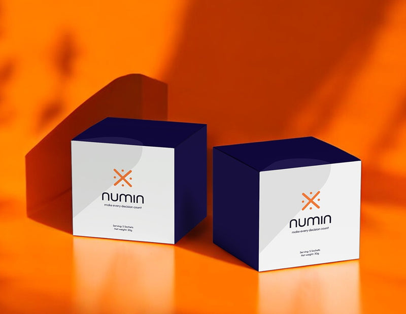 Two navy and white Numin supplement boxes on a bright orange background.