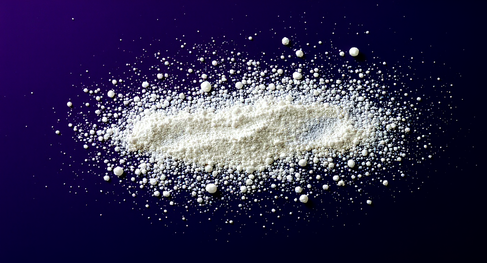 White nootropic supplement powder scattered on dark blue background
