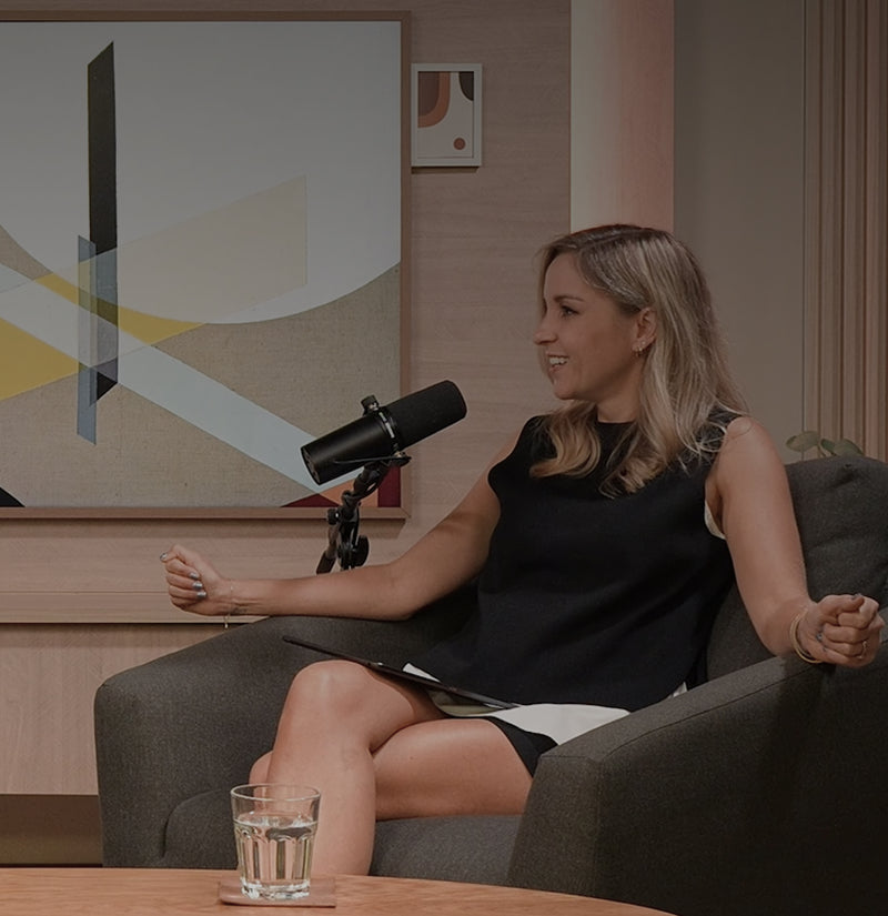 Woman speaking into microphone during podcast recording about decision fatigue and mental clarity