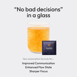 Glass of orange focus supplement drink with Numin packet for improved communication and sharper focus